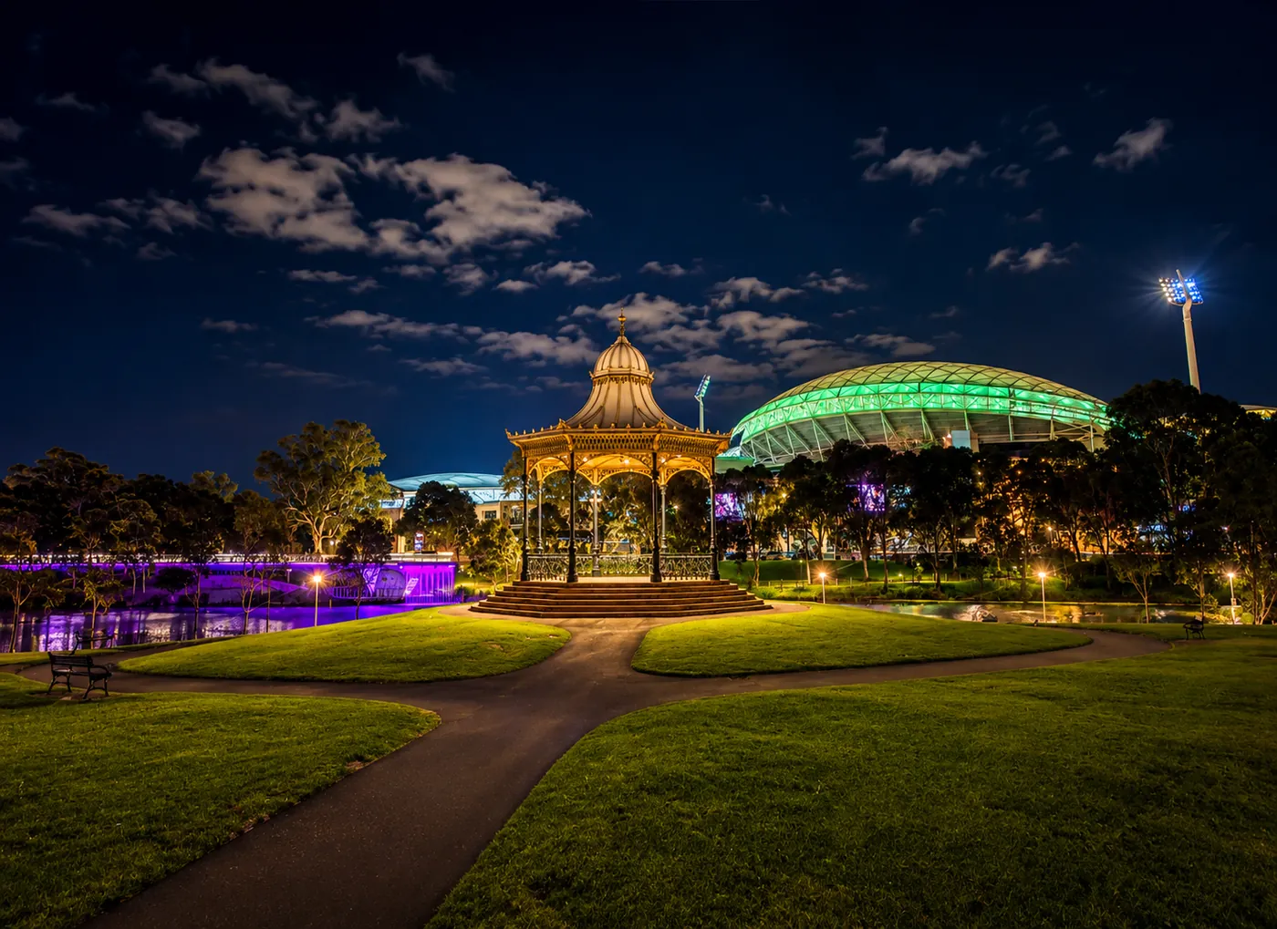 Adelaide's Elder Park rotunda and Adelaide Oval illuminated at night beside the River Torrens