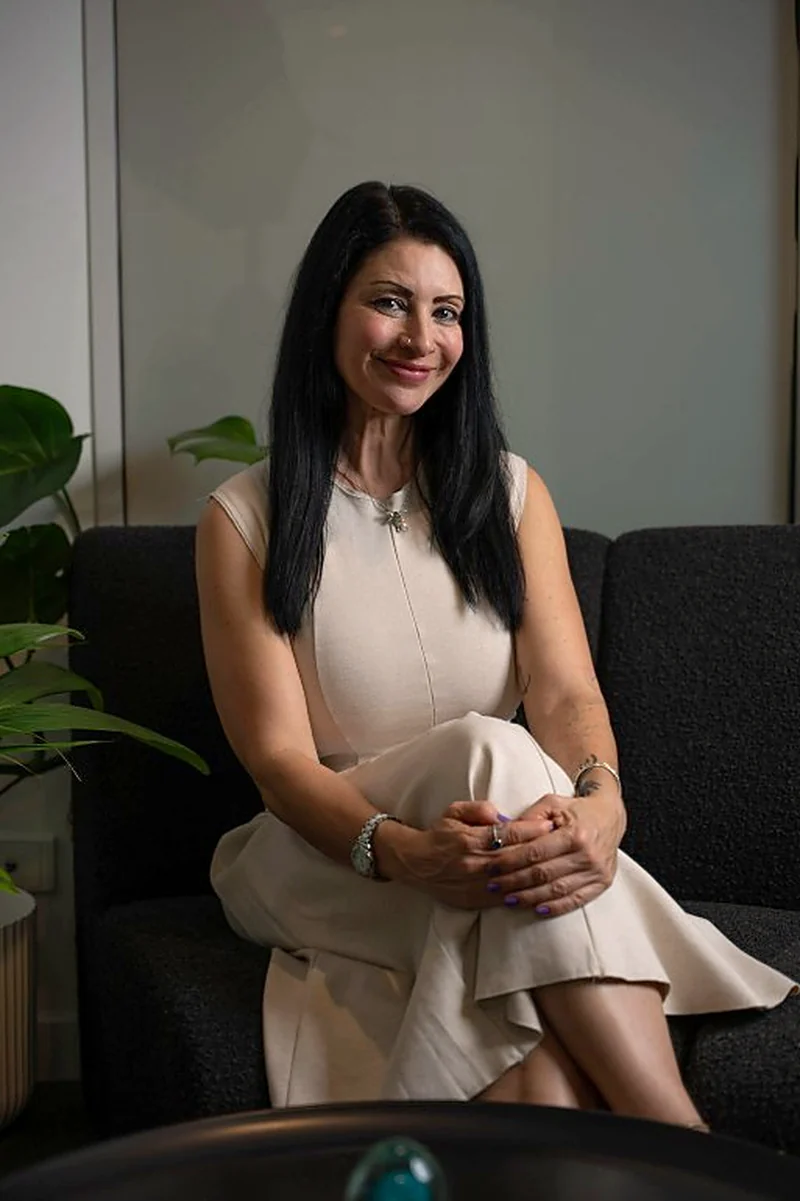 Janina seated, relaxed and smiling, ready to talk about your property plans